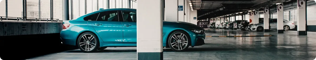 Turquoise car in a parking garage, photograph from the official NarsCars About page